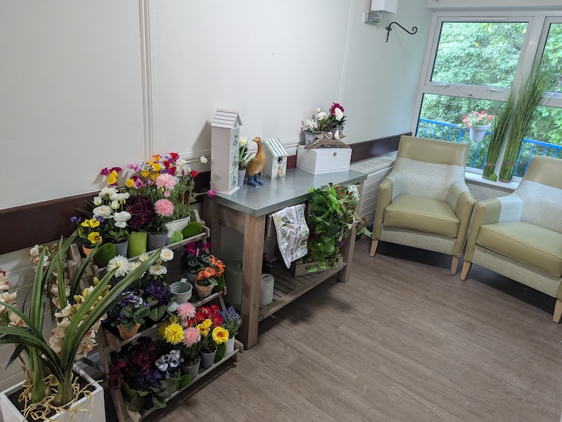 Victoria Mews indoor garden with flowers by large window