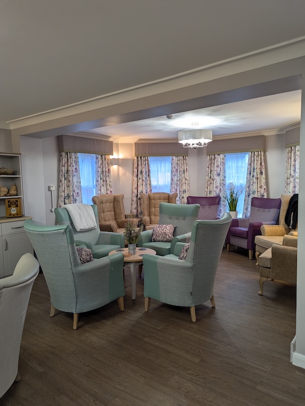 Victoria Mews lounge with blue and purple armchairs in a circle
